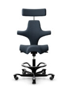 Flokk HÅG Capisco ergonomic task chair with adjustable height and tilt mechanism. Black chair shown with optional neck/headrest support and foot ring.