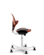 Adjustable Flokk Capisco Puls chair with five-star base and seat pad.