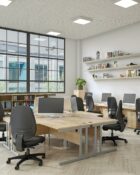 Double upright radial desk shown in office setting with back to back desks to create a cluster.