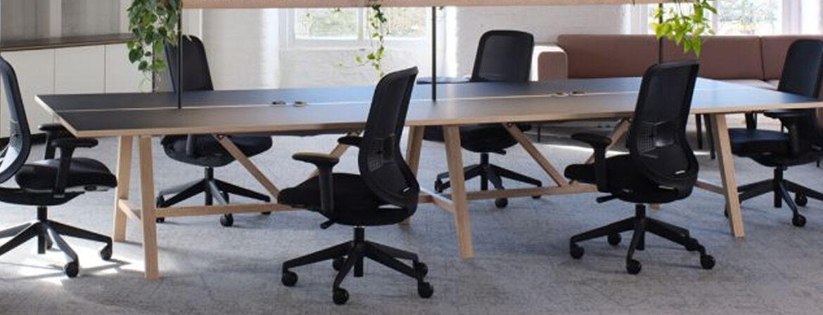 Stylish boardroom table with ergonomic task seating. Chairs shown with mesh backs, black 5 star base and adjustable arms.