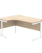 Radial desk with oak top and white frame, shown with cable ports and modesty panels.