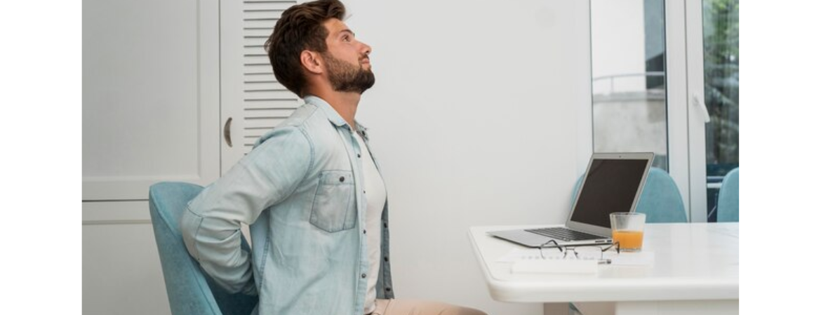 man sitting with incorrect posture at work