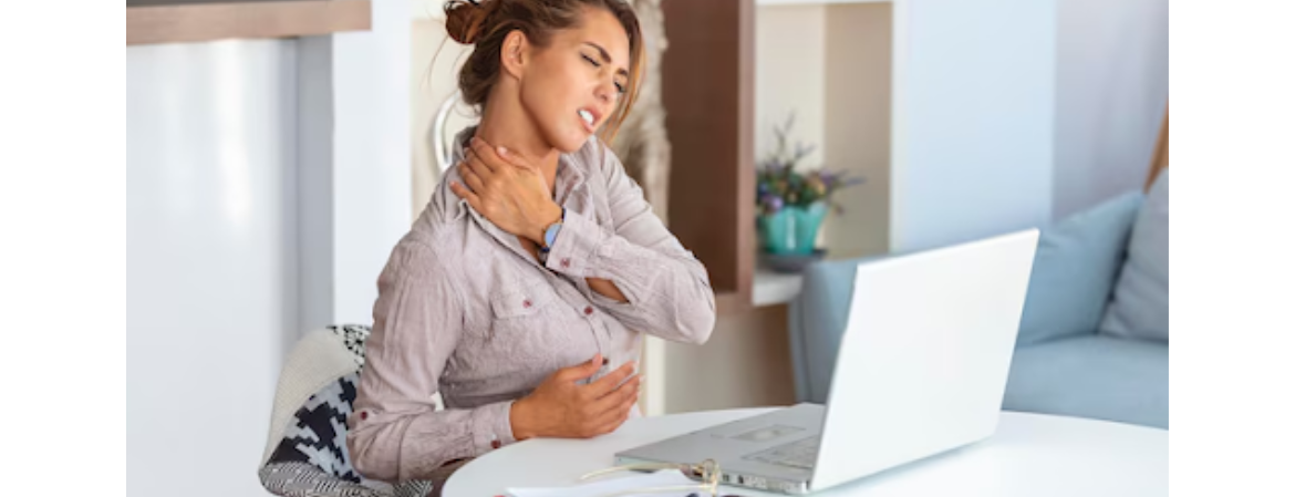 a women with shoulder pain when sat at work