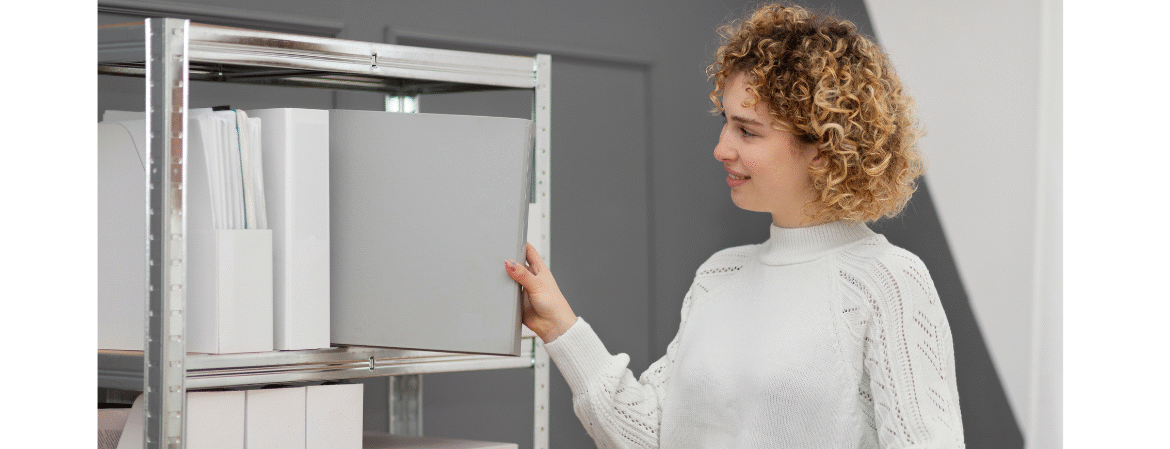 women taking folder from storage shelf